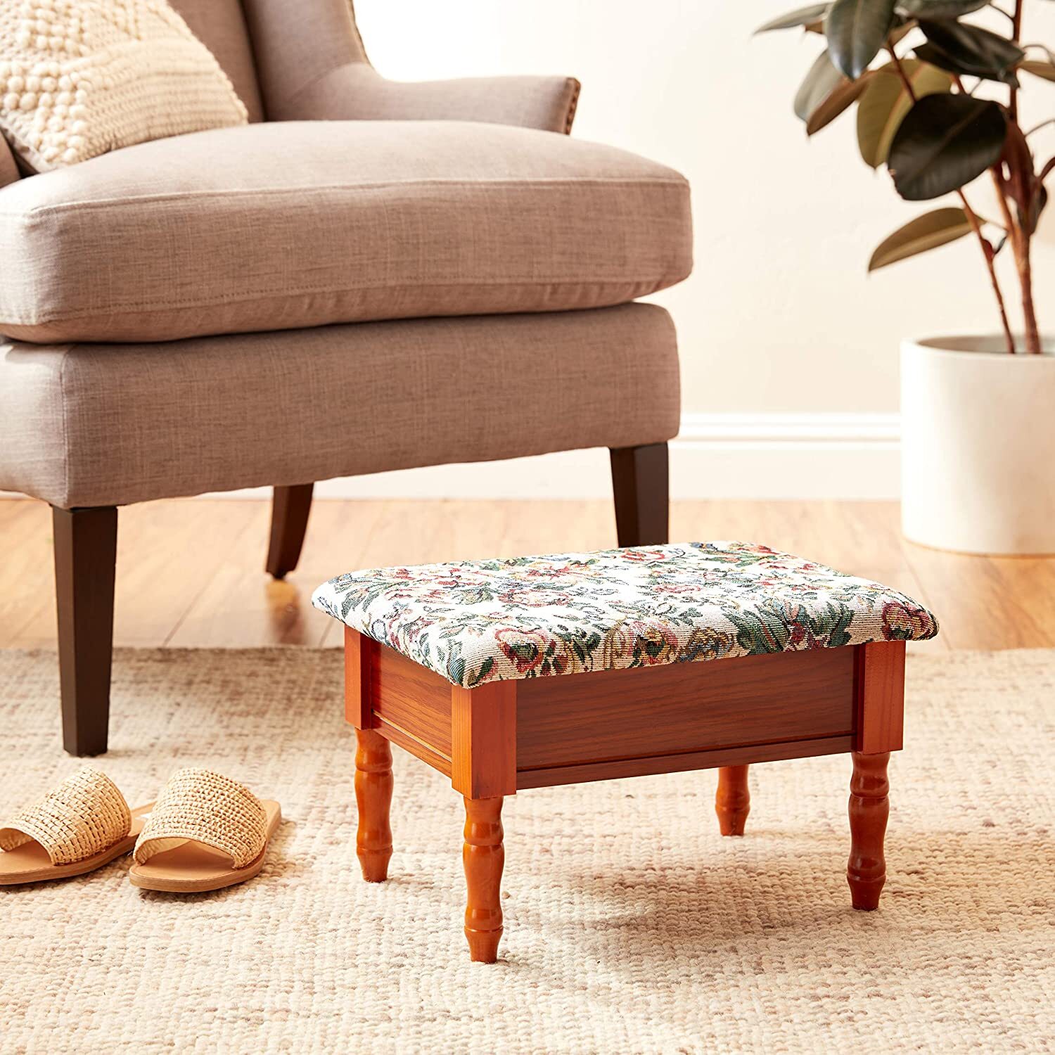 Small upholstered footstool made of wood
