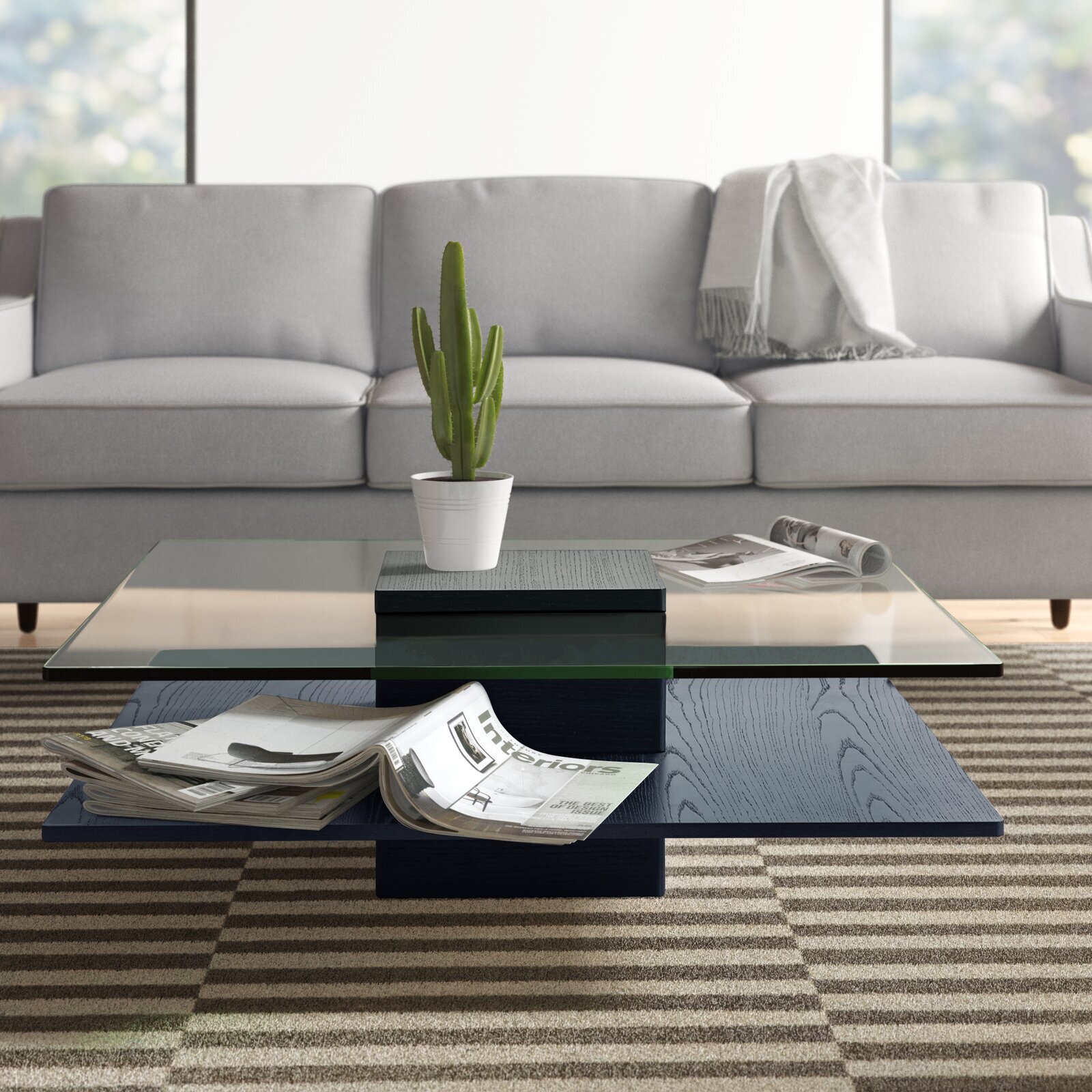 Square coffee table with a black bottom and glass surface