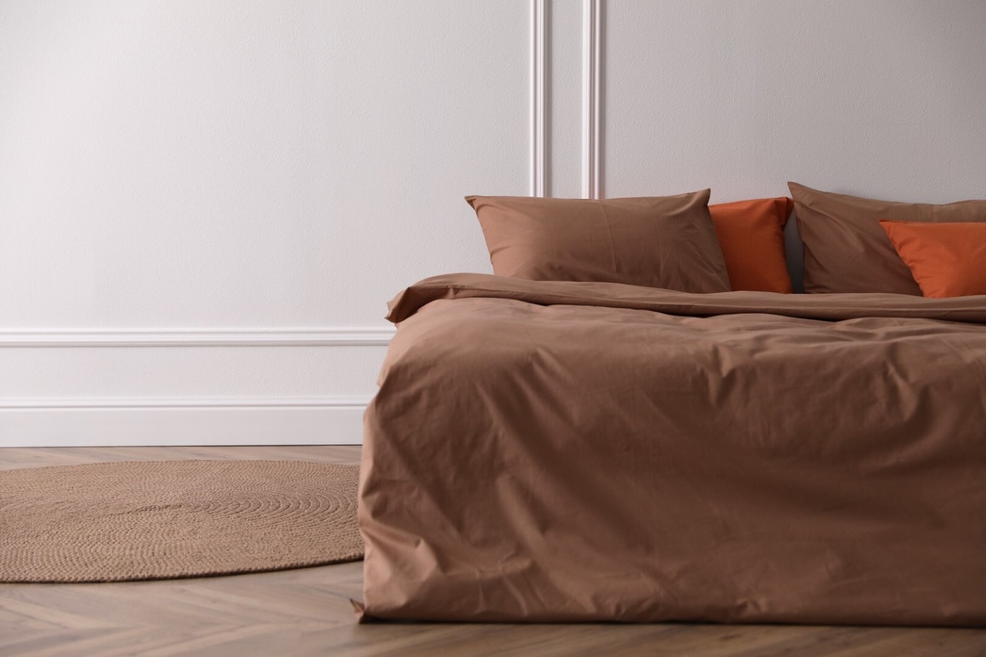 Bed with orange and brown linens