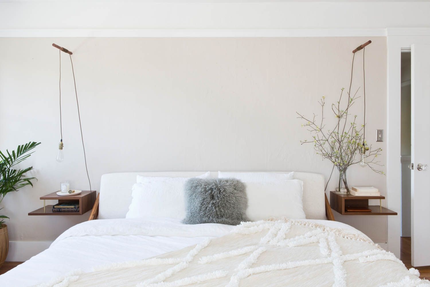 Cozy bed in a white bedroom