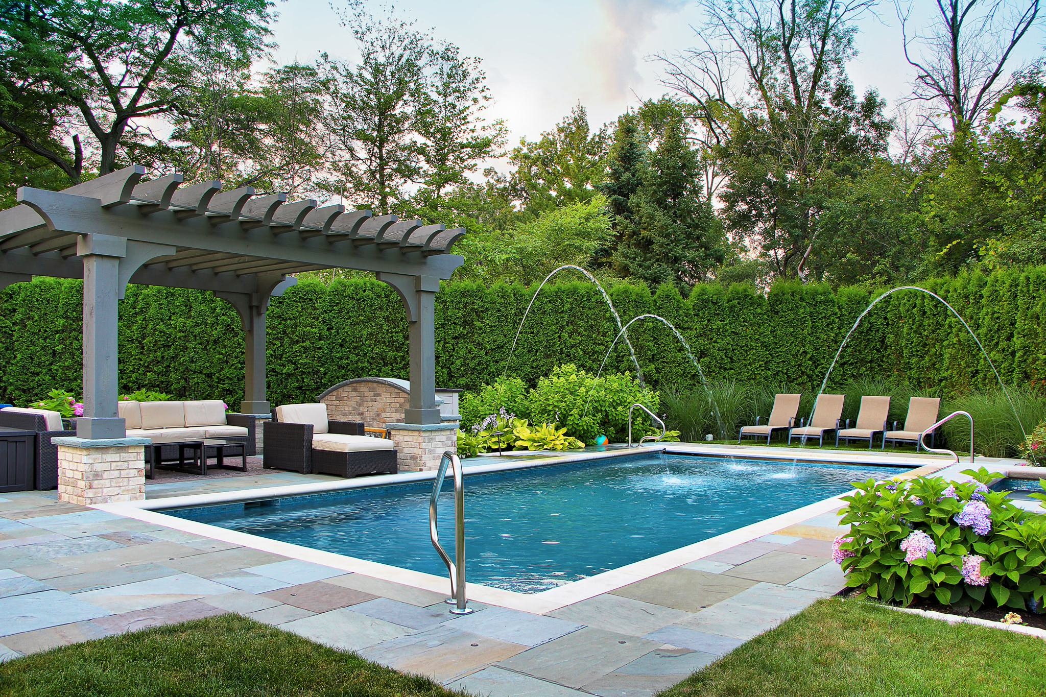 Pool with water features and a pergola