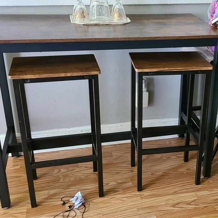 tall narrow table with stools