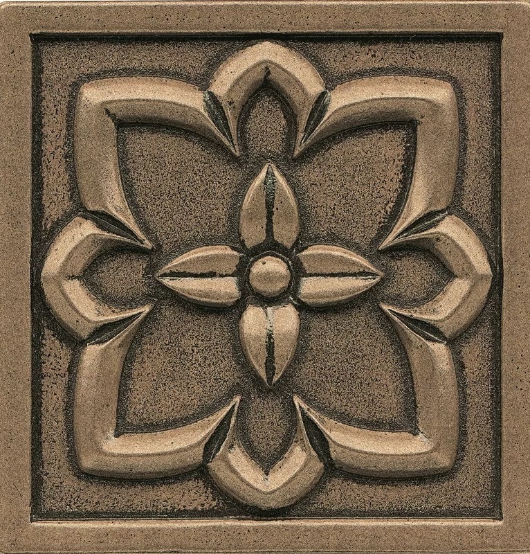 Bronze accent tile backsplash with floral design