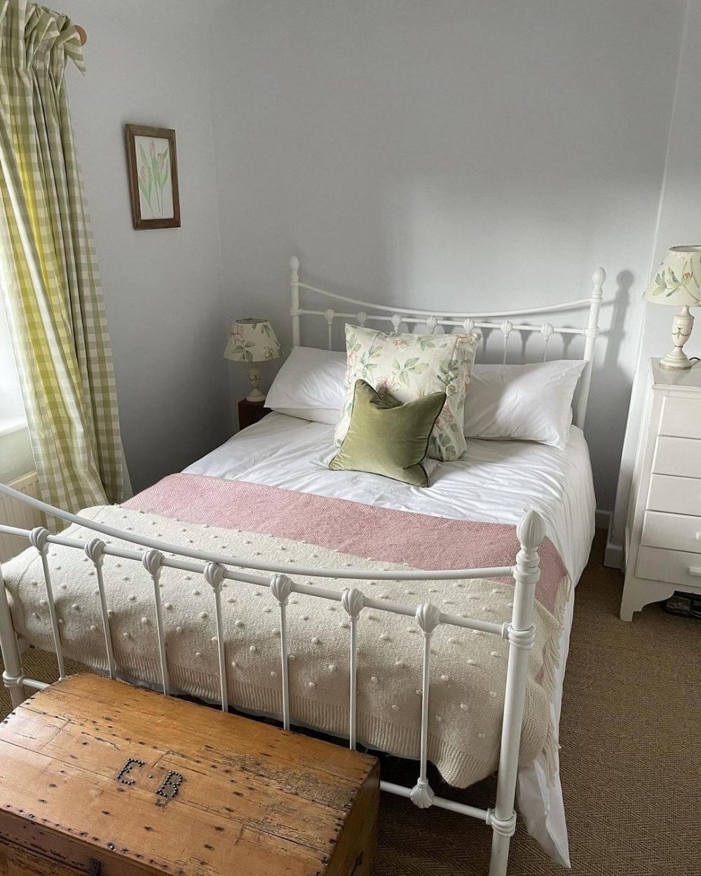 Cottagecore bedroom with a metal bedframe