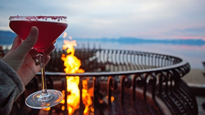enjoying a drink in front of a firepit at dawn enjoying a drink in front of a firepit at dawn