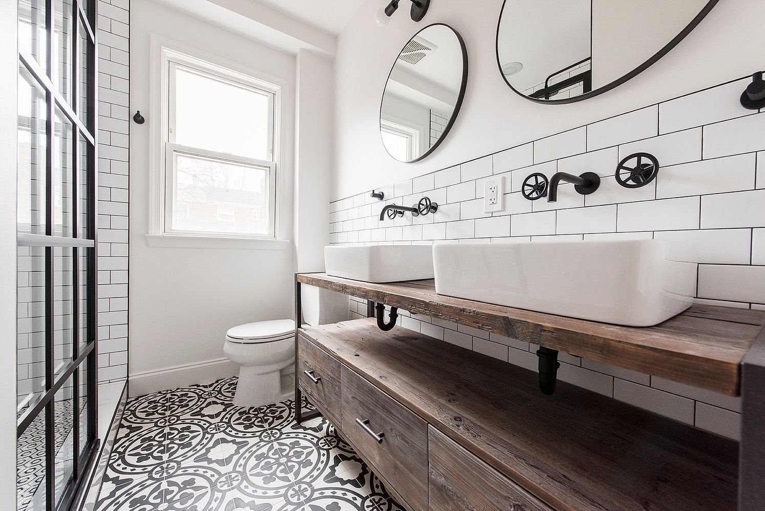 Industrial bathroom with patterned tile flooring