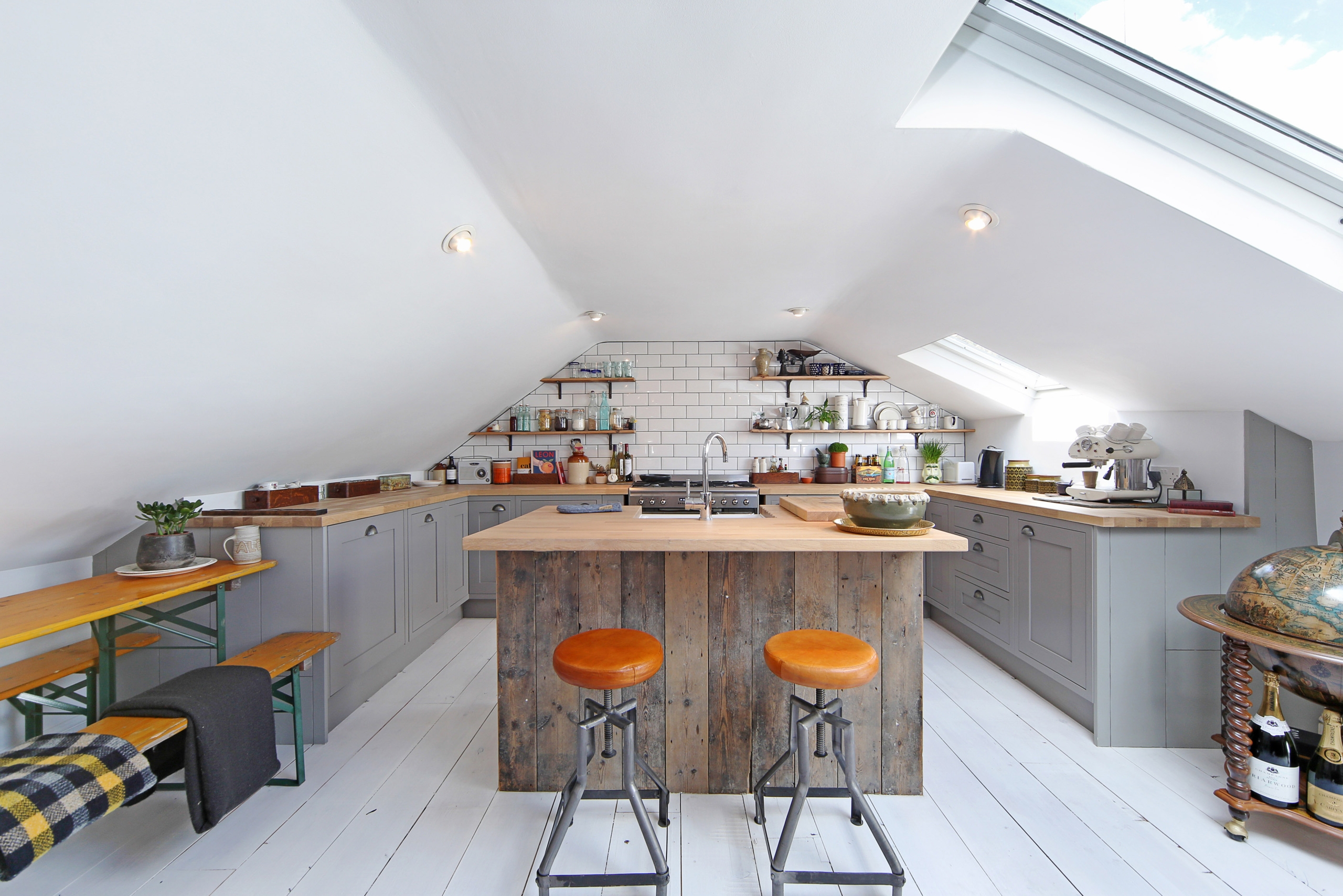Industrial kitchen with sloped ceilings