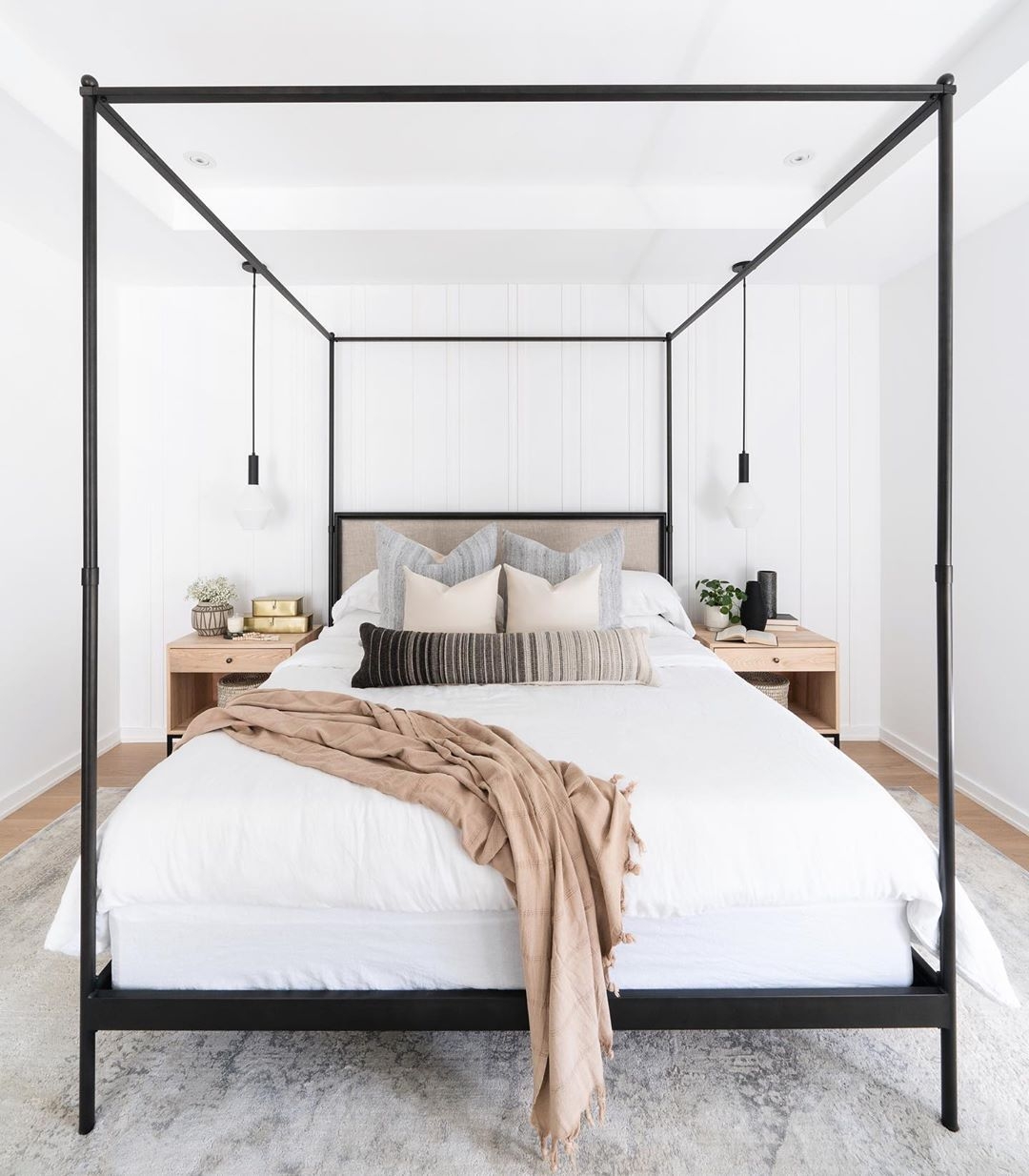 Minimalist bedroom with a poster bed