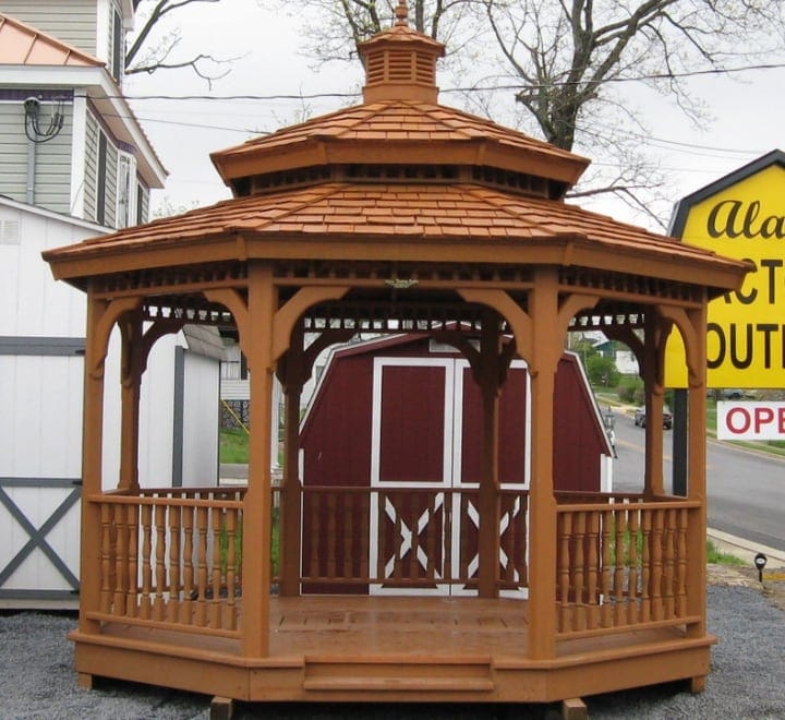 wood gazebo in front of a red barn wood gazebo in front of a red barn