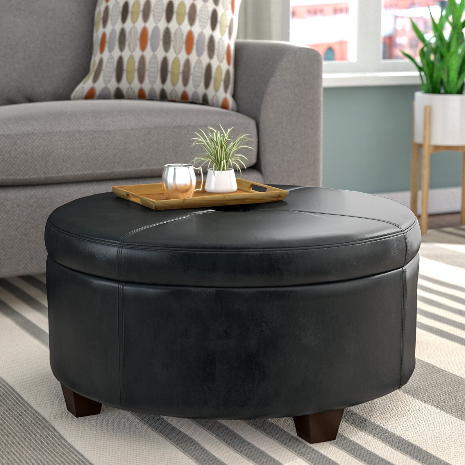 Black round leather coffee table