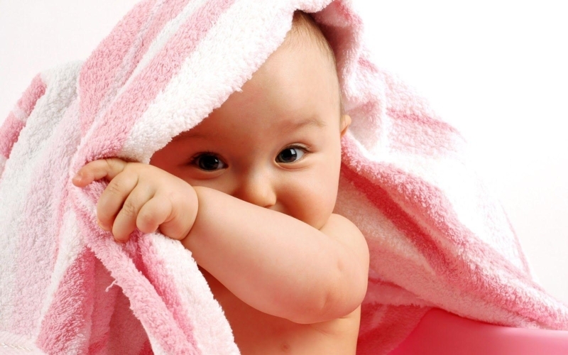 Adorable Baby Boy Wrapped in Soft Pink Towel