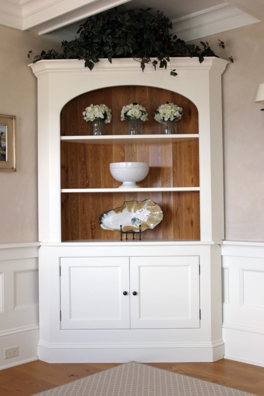 Elegant White Corner Cabinet with Warm Wood Backdrop
